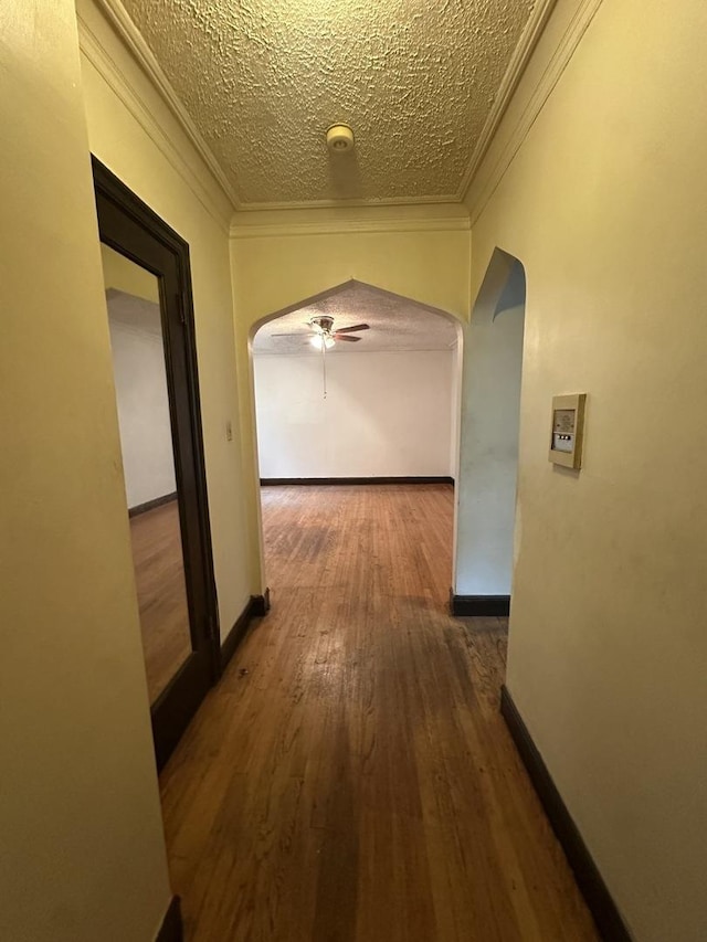 1453 W Elmdale Ave Unit 1, Chicago, IL 60660 - hallway with arched walkways, ornamental molding, wood finished floors, and a textured ceiling