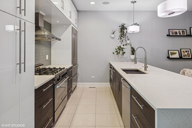1350 W Diversey Pkwy Unit 1, Chicago, IL 60614 - kitchen featuring stainless steel appliances, a peninsula, wall chimney exhaust hood, backsplash, and dark brown cabinets