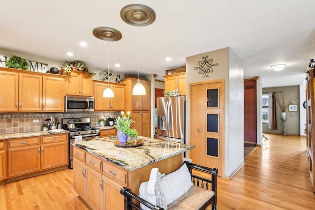 949 Ruthenbeck Ln, New Lenox, IL 60451 - kitchen with stainless steel appliances, a kitchen island, tasteful backsplash, light wood-style floors, and recessed lighting