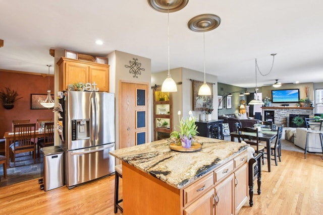 949 Ruthenbeck Ln, New Lenox, IL 60451 - kitchen featuring stainless steel fridge, ceiling fan, a kitchen bar, light wood-type flooring, and a kitchen island