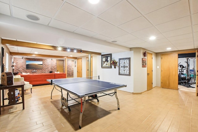 949 Ruthenbeck Ln, New Lenox, IL 60451 - game room with a drop ceiling, brick wall, and light wood finished floors