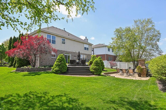 949 Ruthenbeck Ln, New Lenox, IL 60451 - back of property with a wooden deck, a patio, and brick siding