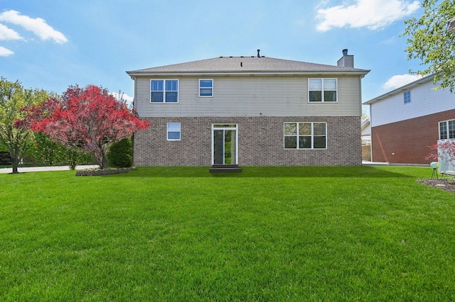 949 Ruthenbeck Ln, New Lenox, IL 60451 - rear view of house with a yard, a chimney, and brick siding