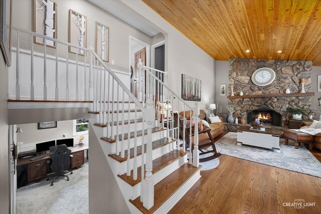 124 Fairview Dr, Saint Charles, IL 60174 - stairs with wooden ceiling, wood finished floors, a stone fireplace, recessed lighting, and lofted ceiling