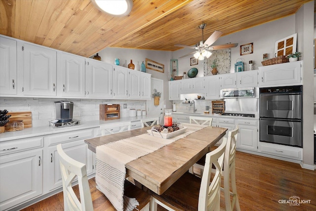 124 Fairview Dr, Saint Charles, IL 60174 - kitchen with stainless steel appliances, tasteful backsplash, white cabinetry, wood ceiling, and a ceiling fan