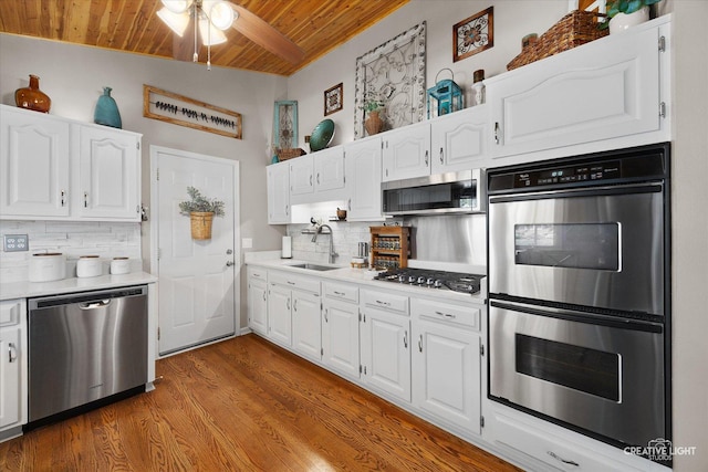 124 Fairview Dr, Saint Charles, IL 60174 - kitchen featuring stainless steel appliances, wood ceiling, decorative backsplash, a ceiling fan, and white cabinetry
