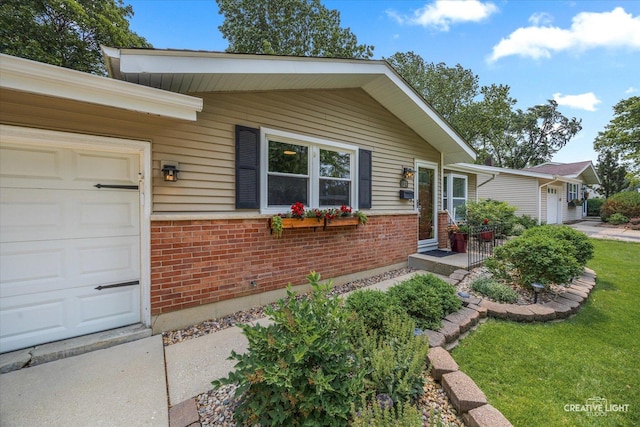 124 Fairview Dr, Saint Charles, IL 60174 - view of front facade with brick siding, an attached garage, and a front lawn