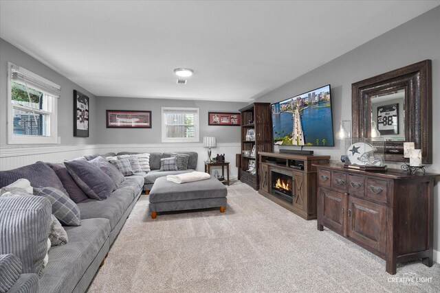 124 Fairview Dr, Saint Charles, IL 60174 - living area featuring light colored carpet, healthy amount of natural light, and a warm lit fireplace