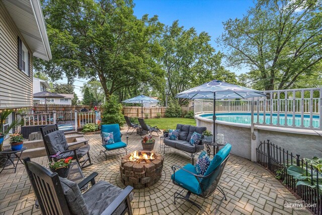 124 Fairview Dr, Saint Charles, IL 60174 - fenced backyard with an outdoor living space with a fire pit and a patio area