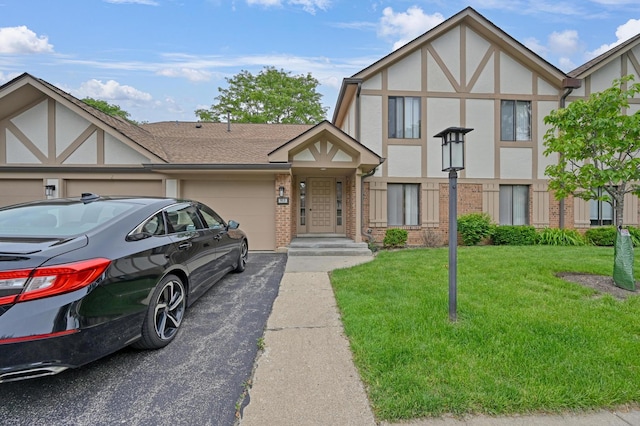 912 Knottingham Dr Unit 1B, Schaumburg, IL 60193 - tudor home featuring a garage, brick siding, driveway, and a front yard