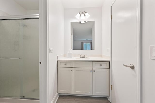 912 Knottingham Dr Unit 1B, Schaumburg, IL 60193 - bathroom featuring vanity, a stall shower, and wood finished floors