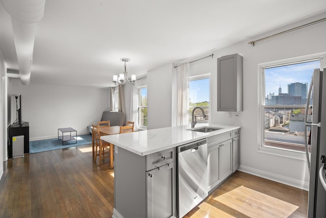 1322 W Huron St Unit 4N, Chicago, IL 60642 - kitchen featuring appliances with stainless steel finishes, a peninsula, gray cabinets, a chandelier, and open floor plan
