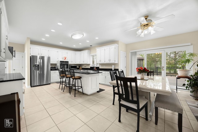 401 Jason Ln, Schaumburg, IL 60173 - kitchen featuring stainless steel appliances, plenty of natural light, white cabinetry, dark countertops, and recessed lighting
