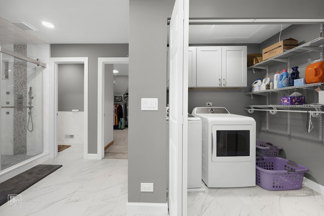 401 Jason Ln, Schaumburg, IL 60173 - laundry room with cabinet space, washing machine and clothes dryer, and light marble finish flooring