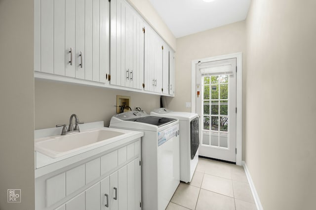 401 Jason Ln, Schaumburg, IL 60173 - laundry area featuring cabinet space, washer and dryer, and light tile patterned floors