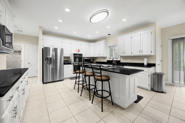401 Jason Ln, Schaumburg, IL 60173 - kitchen with stainless steel appliances, plenty of natural light, light tile patterned floors, white cabinetry, and recessed lighting