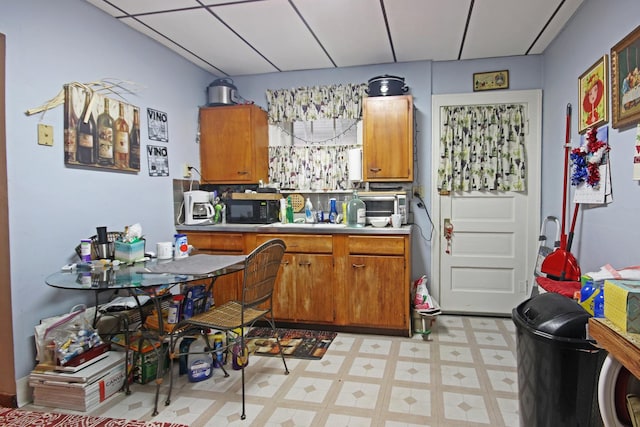 2424 Birch Ave, Whiting, IN 46394 - kitchen featuring light floors, brown cabinetry, black microwave, and light countertops