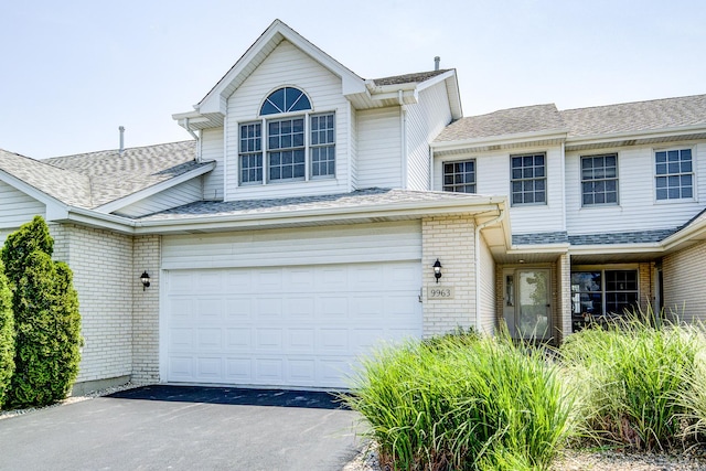 9963 Constitution Dr, Orland Park, IL 60462 - view of front of property with brick siding, driveway, an attached garage, and a shingled roof