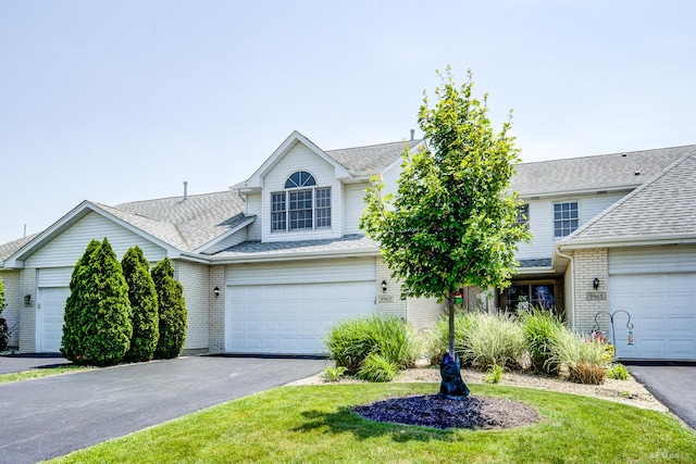 9963 Constitution Dr, Orland Park, IL 60462 - traditional-style house featuring brick siding, asphalt driveway, roof with shingles, and a front yard