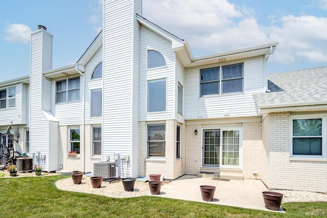 9963 Constitution Dr, Orland Park, IL 60462 - back of house with brick siding, a chimney, a yard, and a patio area