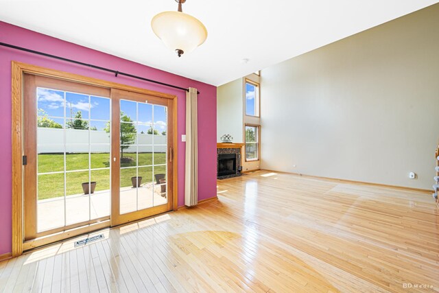 9963 Constitution Dr, Orland Park, IL 60462 - unfurnished living room with wood-type flooring and a fireplace with flush hearth