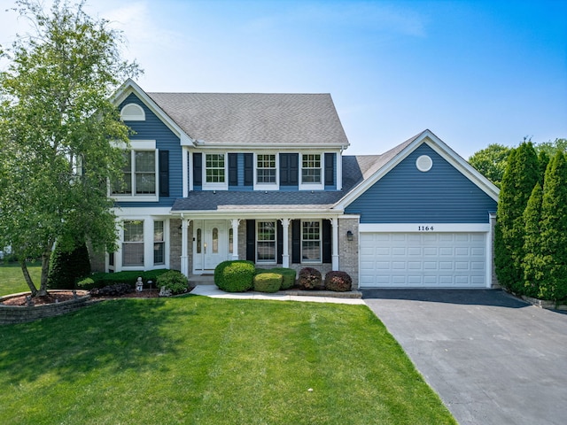1164 Winding Glen Dr, Carol Stream, IL 60188 - view of front facade featuring a porch, asphalt driveway, an attached garage, a front yard, and roof with shingles