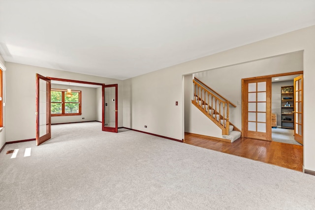 1164 Winding Glen Dr, Carol Stream, IL 60188 - carpeted spare room with french doors and stairway
