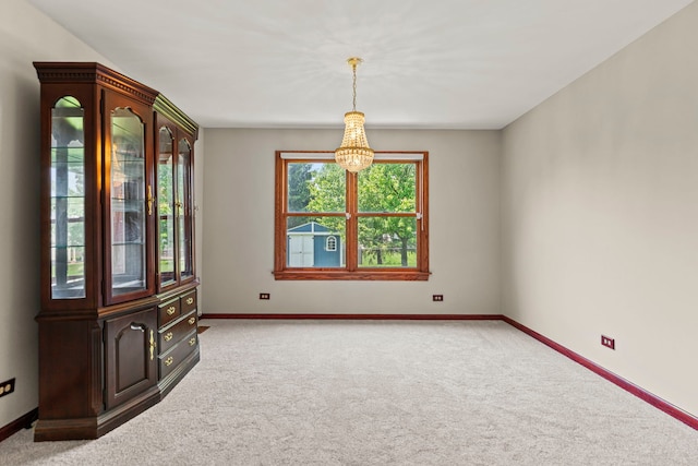 1164 Winding Glen Dr, Carol Stream, IL 60188 - carpeted spare room with baseboards and a chandelier