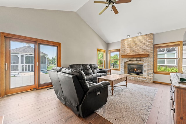 1164 Winding Glen Dr, Carol Stream, IL 60188 - living area with plenty of natural light, light wood-style floors, a ceiling fan, a fireplace, and high vaulted ceiling
