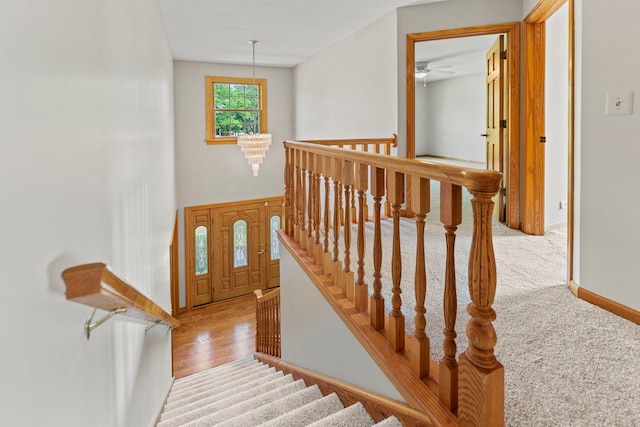 1164 Winding Glen Dr, Carol Stream, IL 60188 - stairs featuring a ceiling fan, a chandelier, wood finished floors, and carpet floors