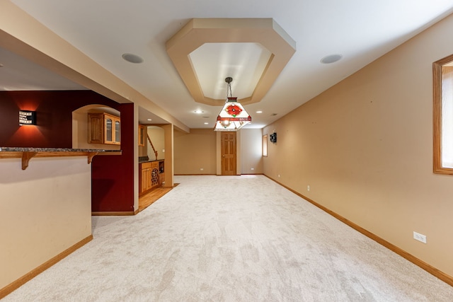 1164 Winding Glen Dr, Carol Stream, IL 60188 - unfurnished living room featuring light carpet, recessed lighting, stairway, and a tray ceiling