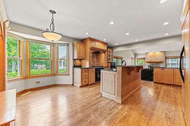 1164 Winding Glen Dr, Carol Stream, IL 60188 - kitchen featuring dark countertops, black oven, light wood-style floors, open floor plan, and glass insert cabinets