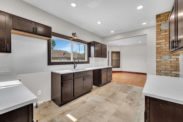 212 S Columbia Ave, Oglesby, IL 61348 - kitchen featuring dark brown cabinetry, tasteful backsplash, recessed lighting, light stone finish floors, and light stone countertops