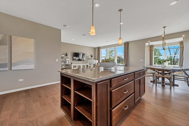 266 Branson Dr, Batavia, IL 60510 - kitchen with open shelves, wood finished floors, light stone countertops, decorative light fixtures, and a kitchen island