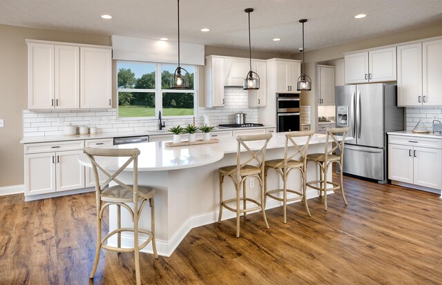 438 Schroeder Trl, Batavia, IL 60510 - kitchen with stainless steel appliances, wood finished floors, backsplash, recessed lighting, and white cabinetry