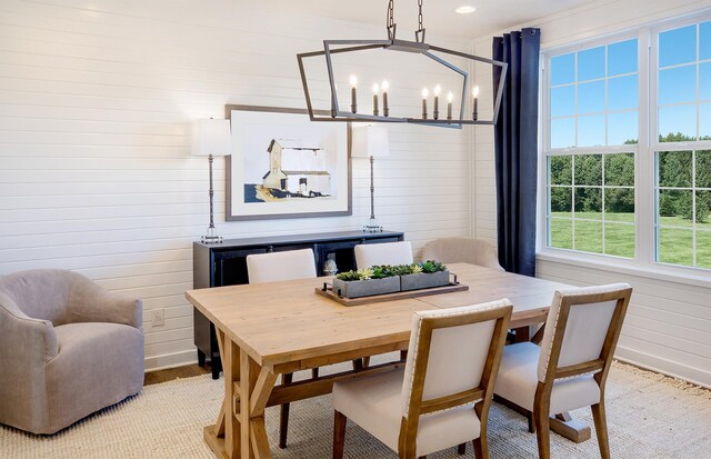 438 Schroeder Trl, Batavia, IL 60510 - dining room featuring a chandelier, baseboards, and wood walls