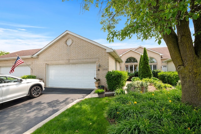 10935 Conifer Ct, Orland Park, IL 60467 - ranch-style home with brick siding, an attached garage, and asphalt driveway