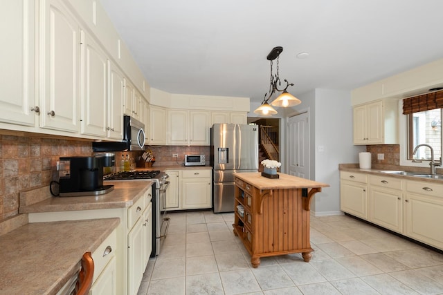 10935 Conifer Ct, Orland Park, IL 60467 - kitchen with appliances with stainless steel finishes, backsplash, light tile patterned floors, and decorative light fixtures