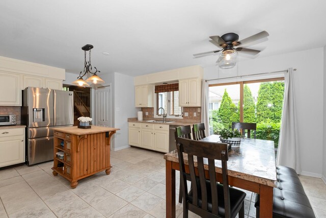 10935 Conifer Ct, Orland Park, IL 60467 - kitchen with stainless steel fridge with ice dispenser, backsplash, a ceiling fan, and light tile patterned floors
