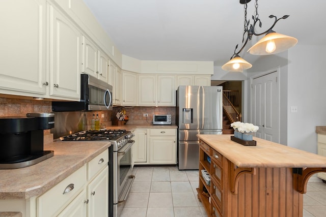 10935 Conifer Ct, Orland Park, IL 60467 - kitchen with appliances with stainless steel finishes, light tile patterned floors, decorative backsplash, butcher block countertops, and pendant lighting