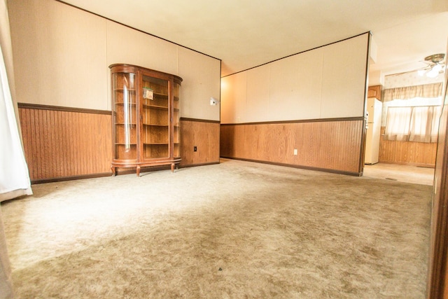 1602 N Jefferson Ave, Dixon, IL 61021 - carpeted spare room featuring wainscoting, wooden walls, and a ceiling fan