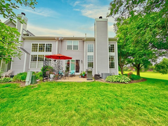 3944 Garnette Ct, Naperville, IL 60564 - rear view of house featuring a chimney, a patio, and a lawn