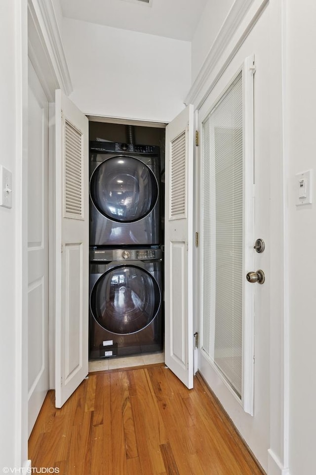 5359 N Paulina St Unit 2, Chicago, IL 60640 - laundry room featuring stacked washing machine and dryer and light wood-type flooring