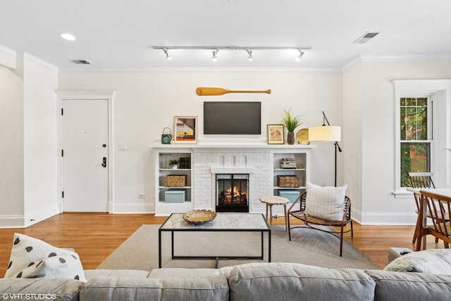5359 N Paulina St Unit 2, Chicago, IL 60640 - living room featuring wood finished floors, a fireplace, and crown molding
