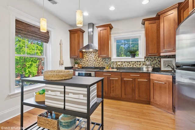5359 N Paulina St Unit 2, Chicago, IL 60640 - kitchen with wall chimney exhaust hood, freestanding refrigerator, plenty of natural light, dark countertops, and recessed lighting