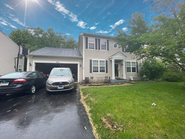 313 Kensington Dr, Oswego, IL 60543 - colonial house featuring driveway, a front lawn, and a garage