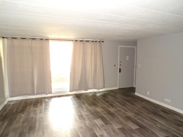 12548 Fairview Ave Unit 2B, Blue Island, IL 60406 - spare room featuring dark wood finished floors and baseboards