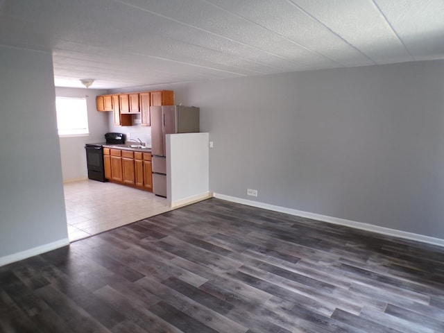 12548 Fairview Ave Unit 2B, Blue Island, IL 60406 - kitchen with black range with electric cooktop, freestanding refrigerator, a sink, dark wood finished floors, and baseboards