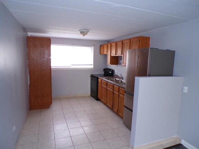 12548 Fairview Ave Unit 2B, Blue Island, IL 60406 - kitchen featuring electric range, baseboards, a sink, light tile patterned floors, and brown cabinetry