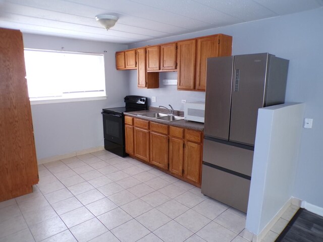 12548 Fairview Ave Unit 2B, Blue Island, IL 60406 - kitchen featuring electric range, white microwave, a sink, freestanding refrigerator, and brown cabinetry